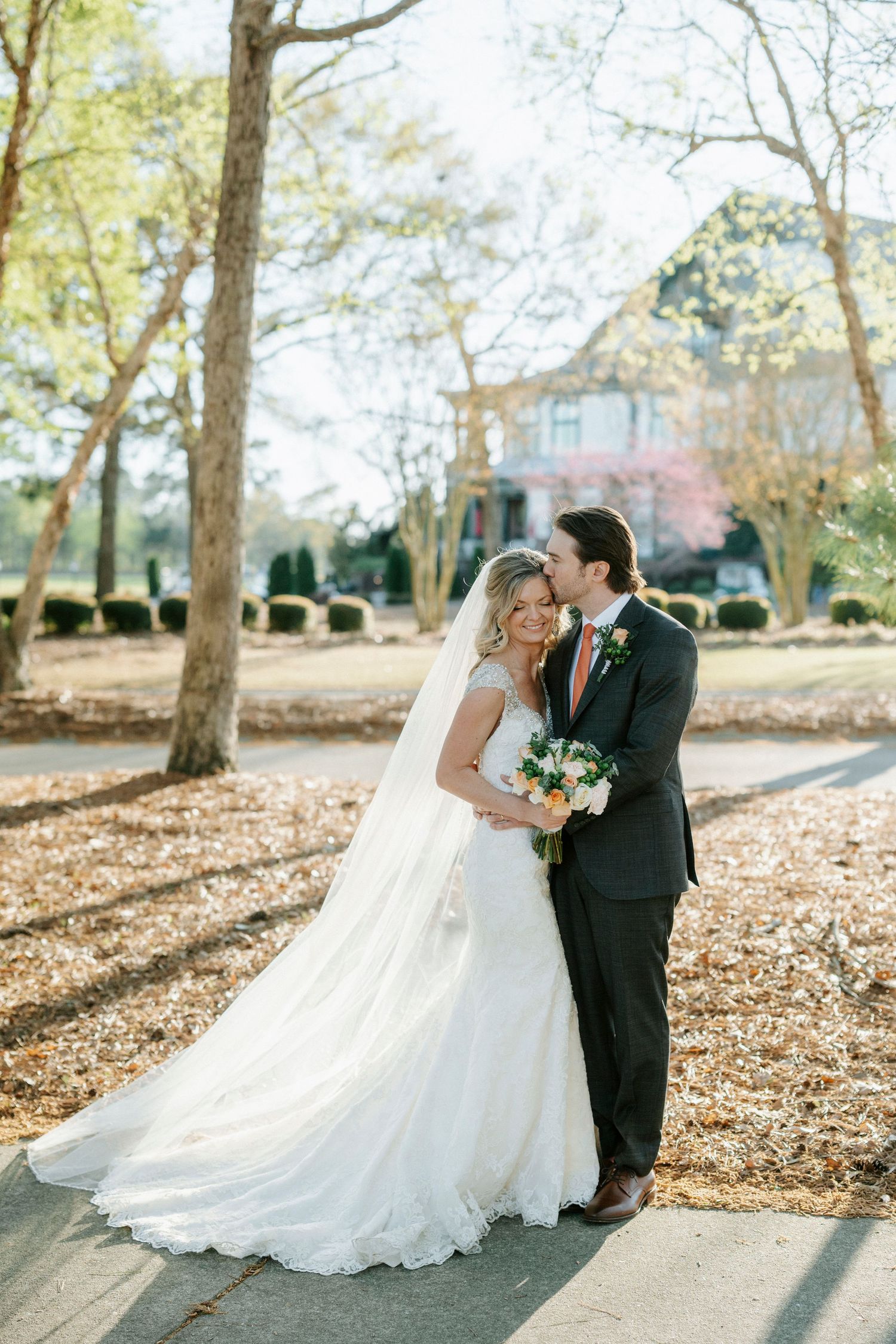 A romantic outdoor wedding photo series showing a couple sharing tender moments among autumn leaves and sunlit trees.