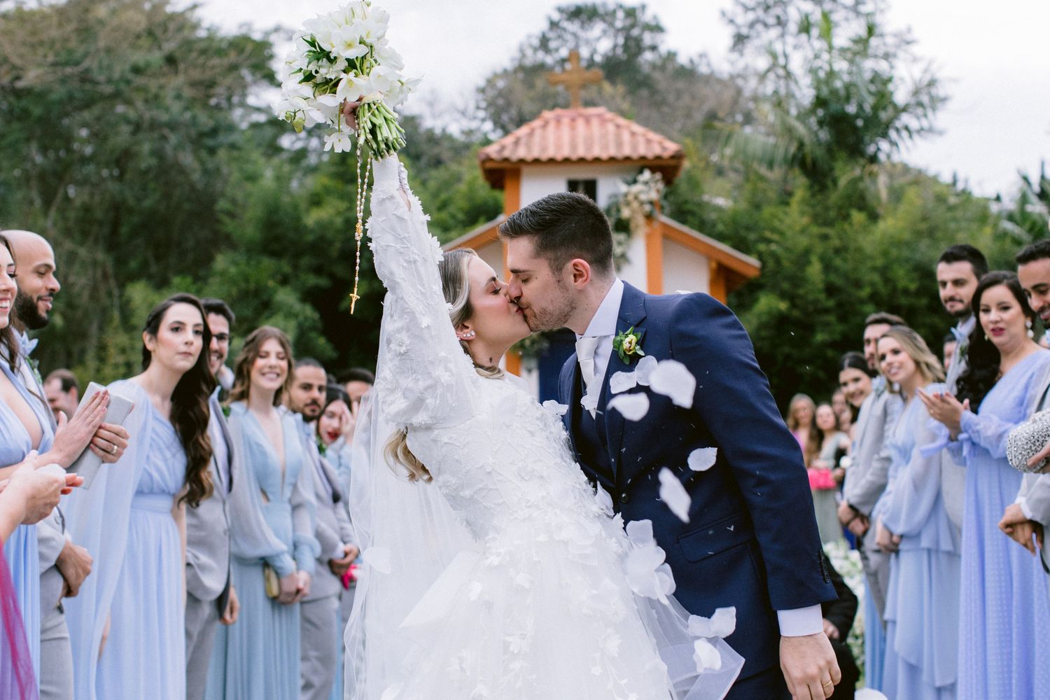 A joyous celebration with confetti and flower petals in an outdoor garden setting.