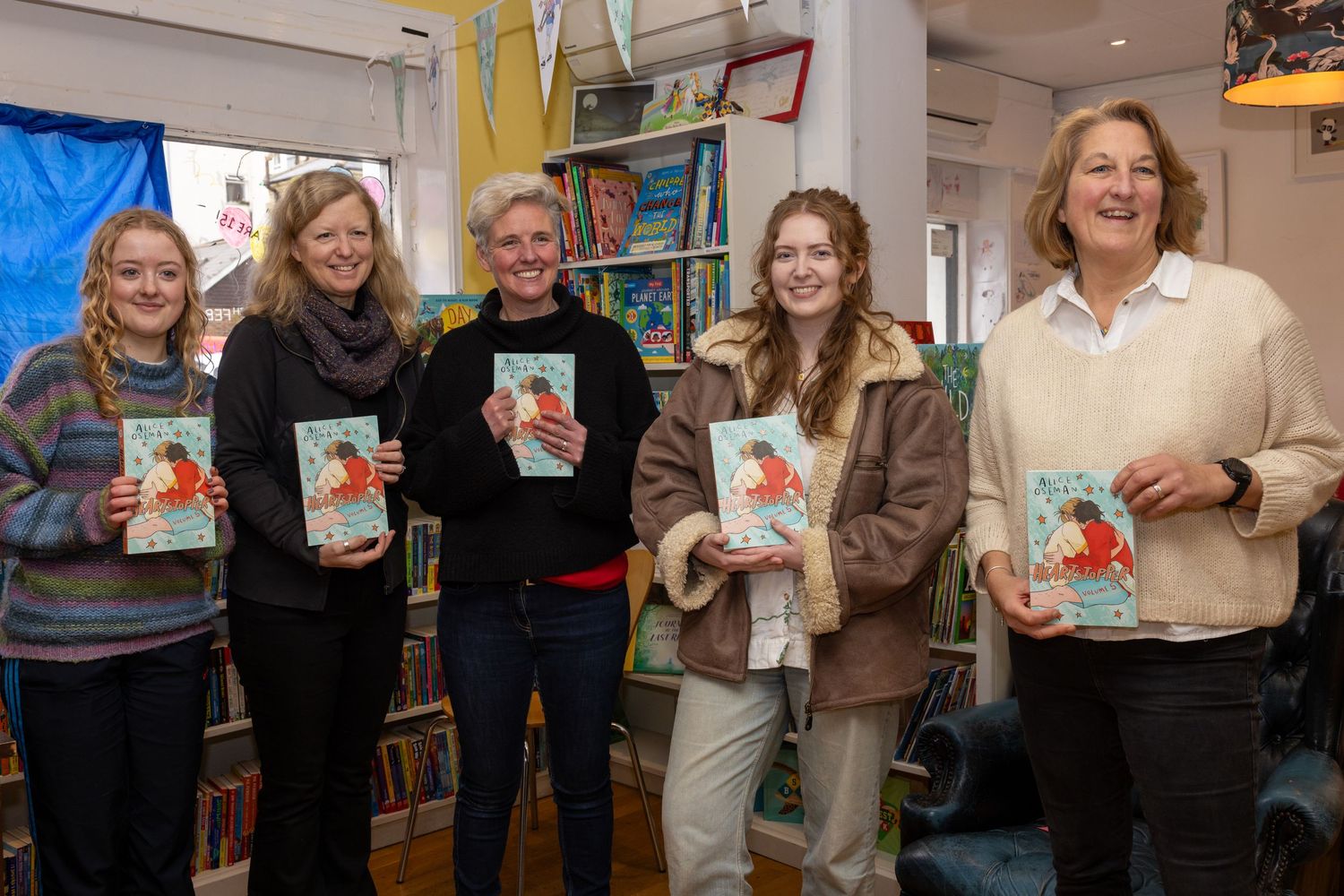The book nook pf Hove team posing with author Alice Oseman