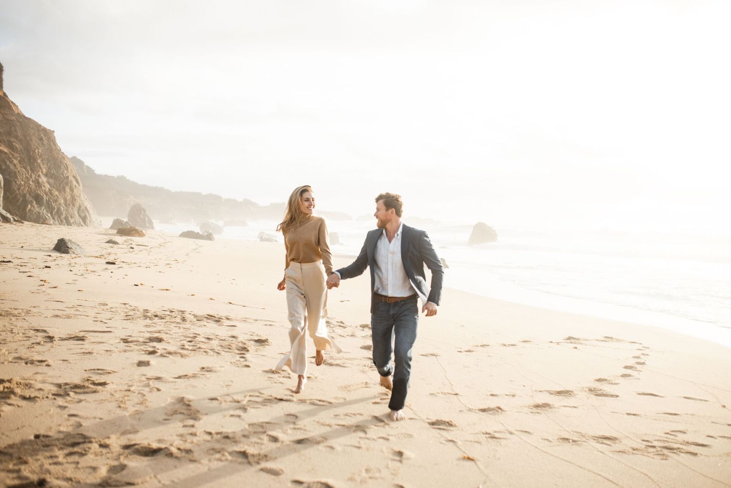 Couple takes engagement photos at garrapata state beach in big sur california with jelau photography