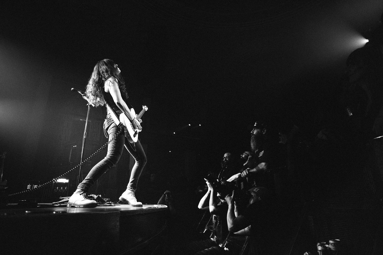 Baroness live performance at The Palace Theatre in Calgary with guitarist playing on stage in dramatic black and white lighting