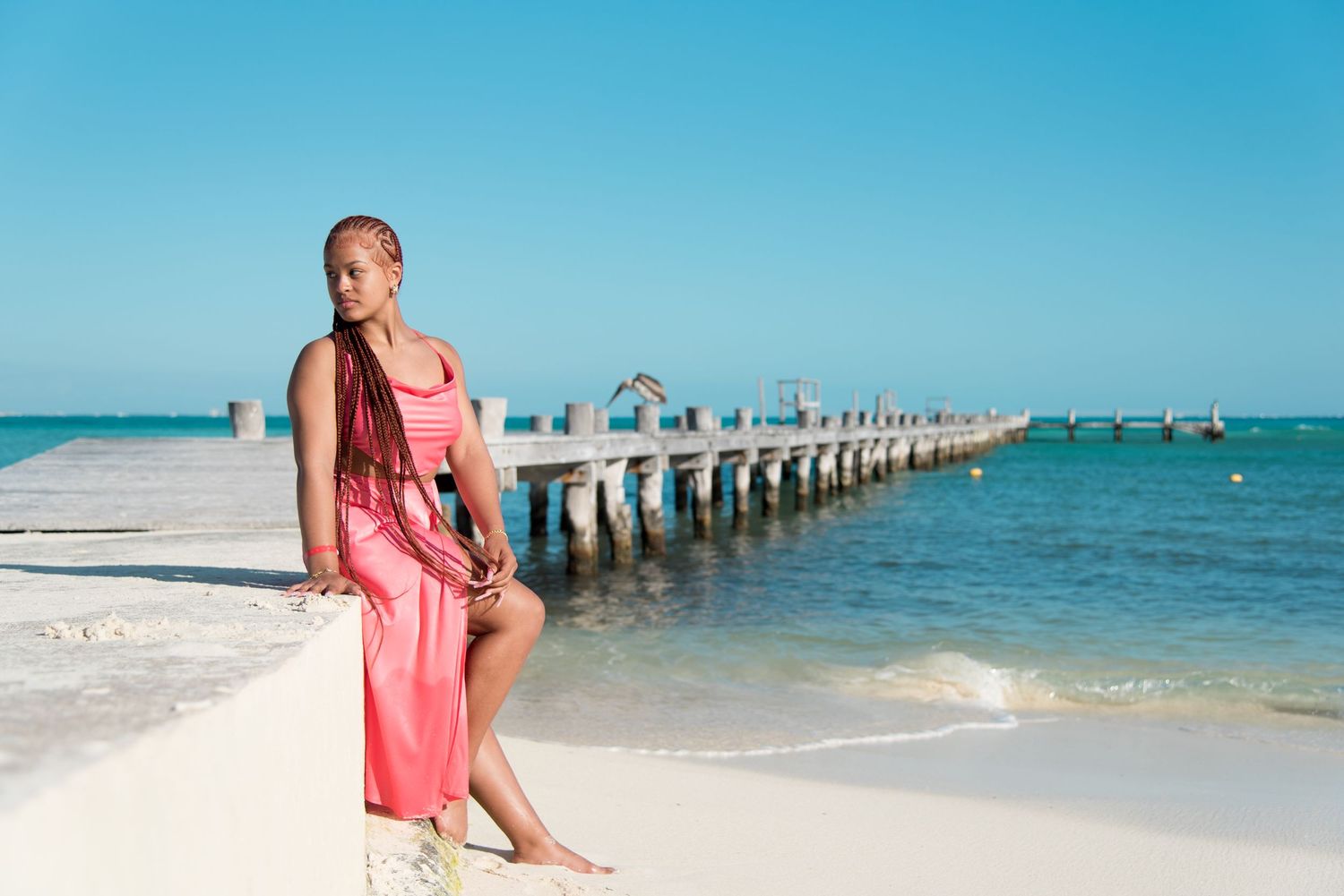 DeJean standing near a dock with the serene ocean in the background