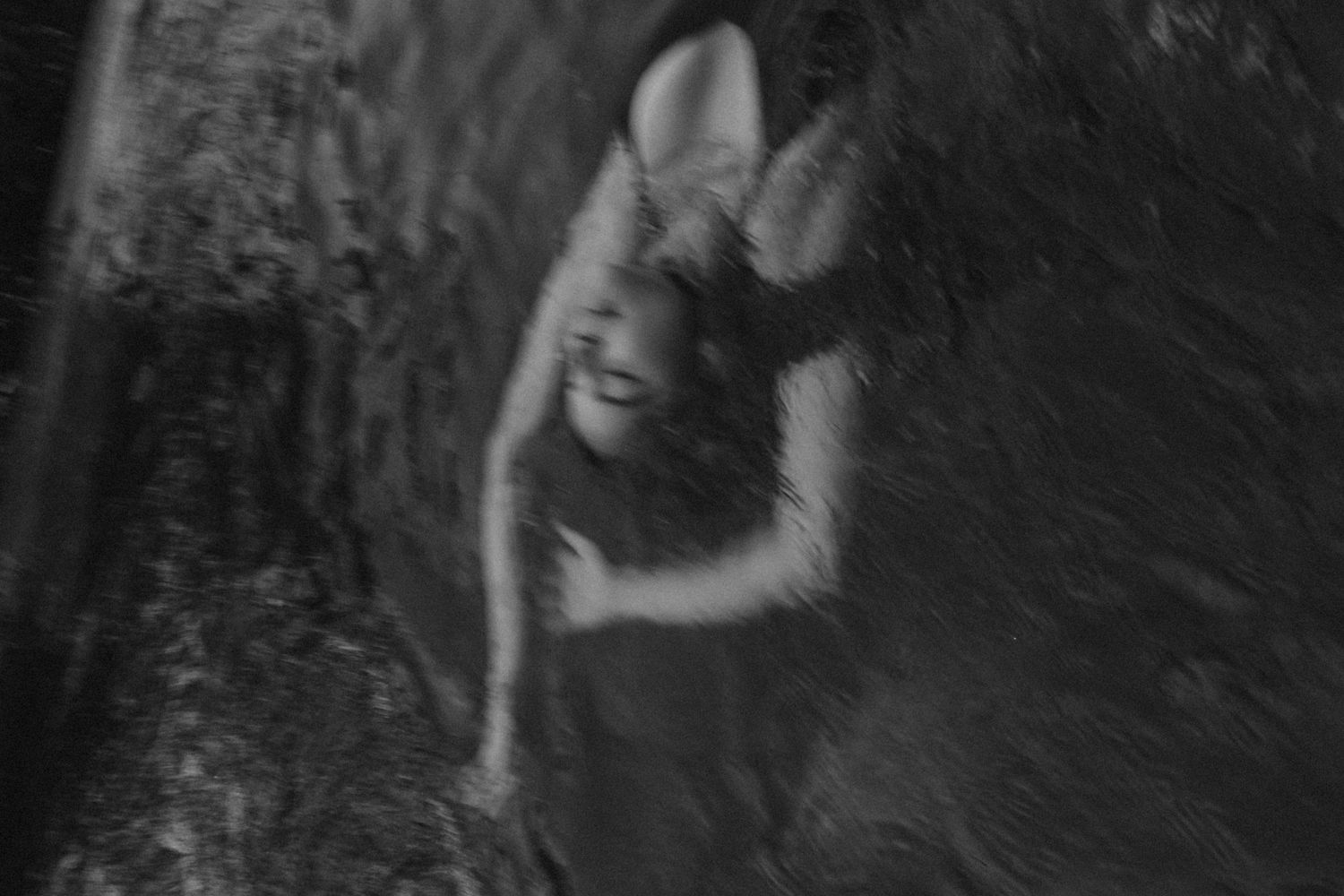Blurry black and white artistic portrait showing movement and ethereal effects.
