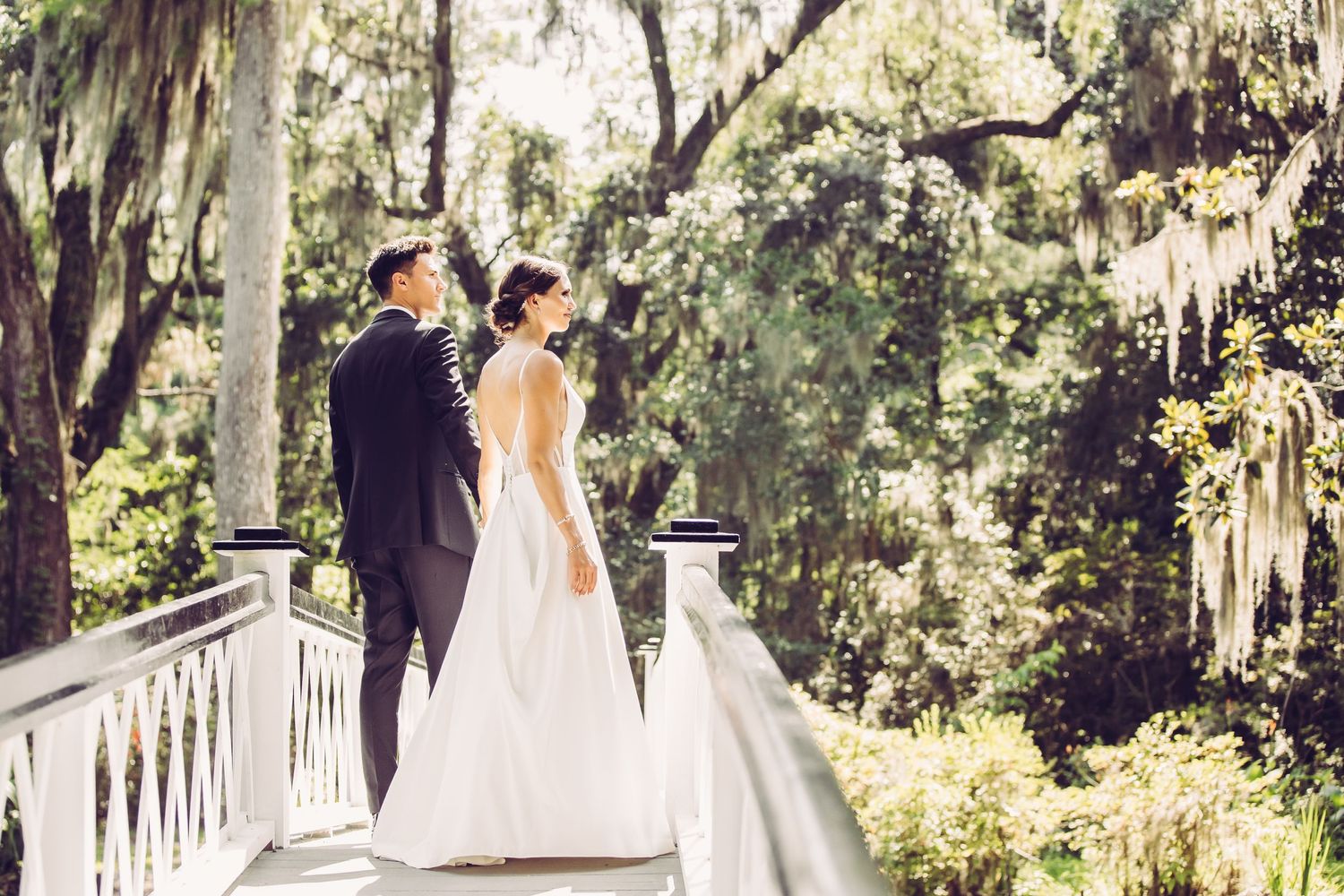 Elegant white columns and Spanish moss create a romantic Southern wedding backdrop.