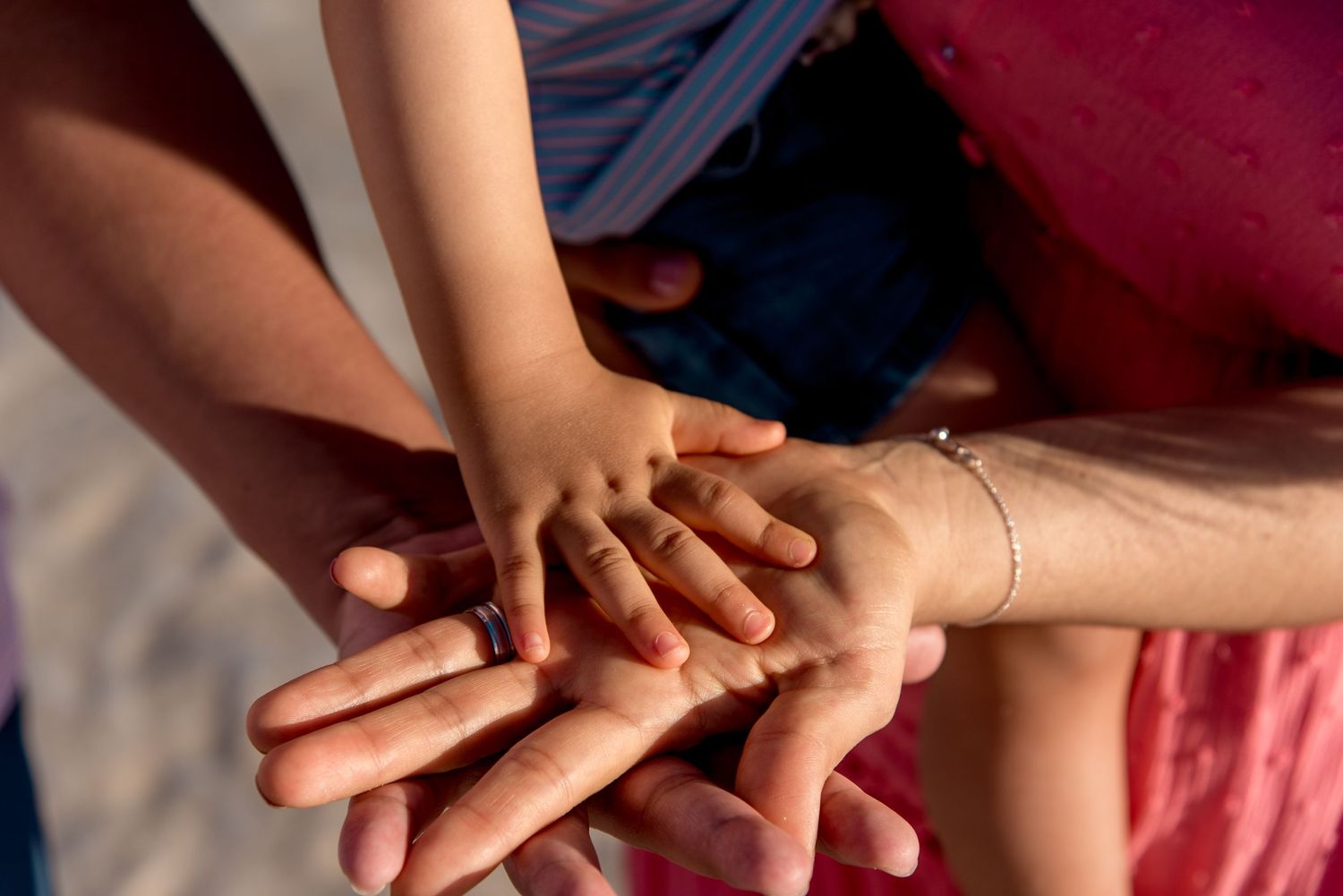 Evelyn and her family putting their hands together as a symbol of love and union