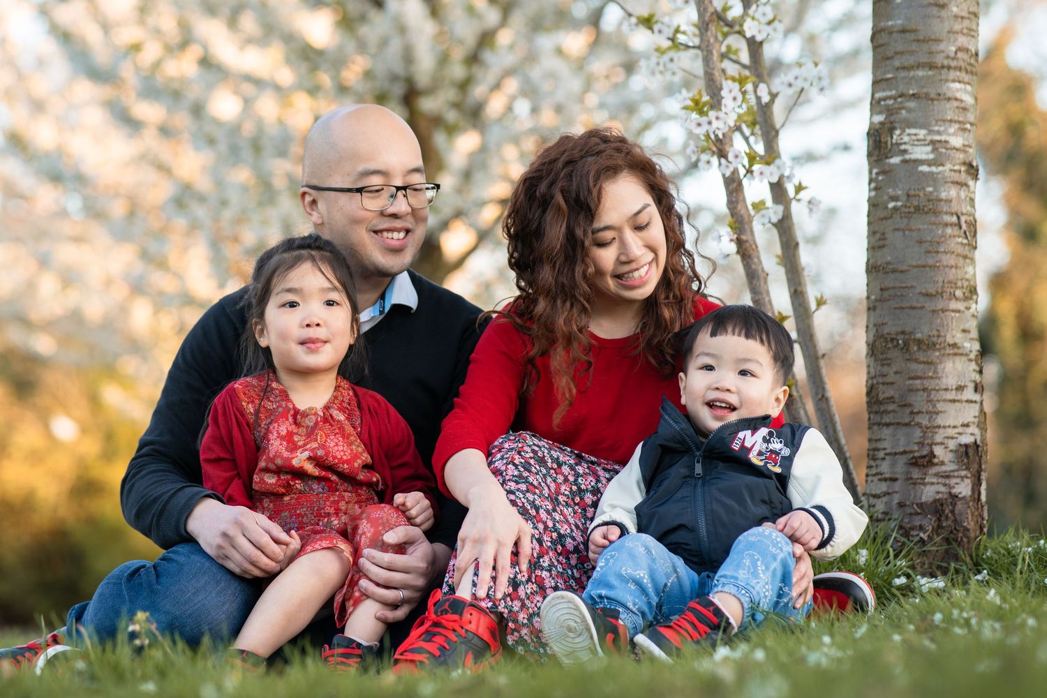 Family in front of cherry blossoms in hullard park manchester