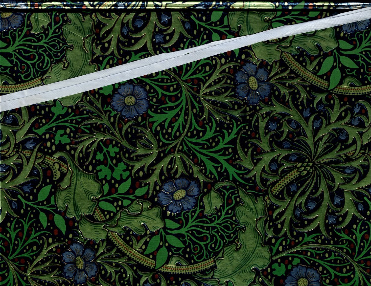 Dark floral fabric with green botanical scrollwork and blue flowers on black background.