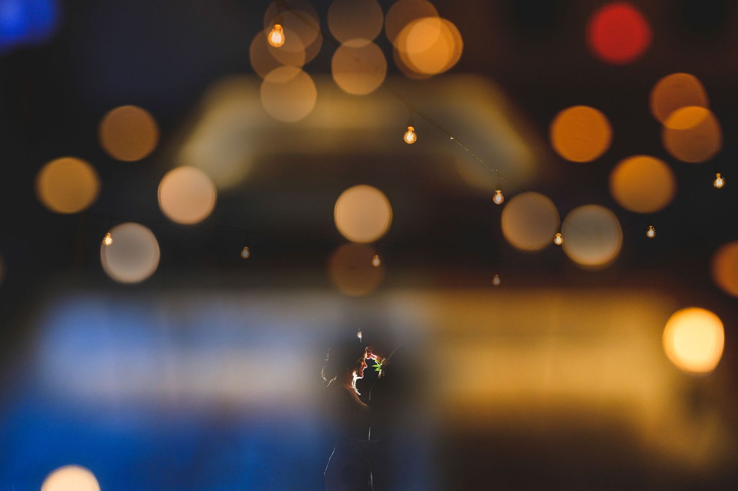 Married couple laughing under multiple exposure lights
