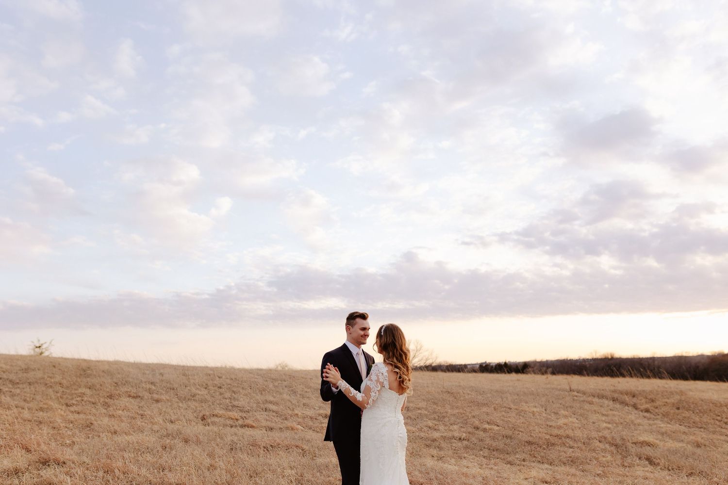 bride and groom during sunset in a field in lincoln nebraska, wedding posing ideas, posing bride and groom for a wedding