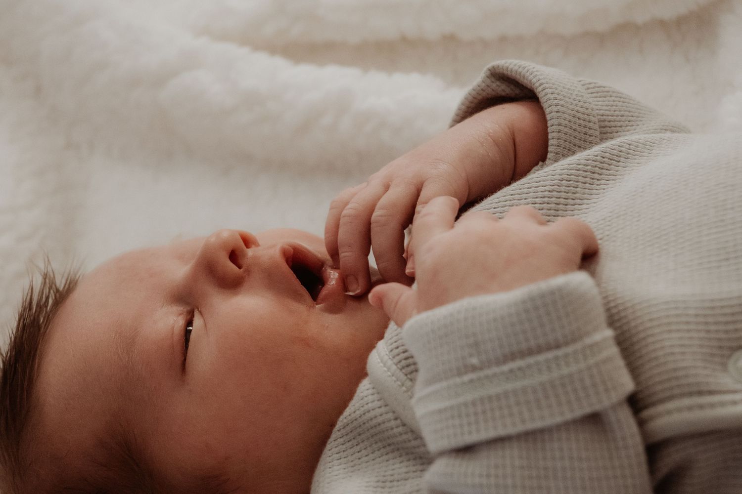 Side profile of a newborn baby at a in home Newborn Photoshoot.