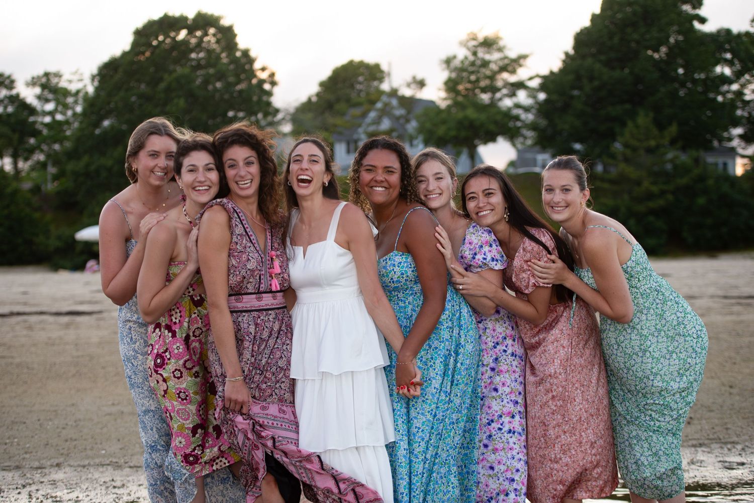 Group of girls laugh at a bachelorette party on the beach in Sandwich, MA on Cape Cod with Leah Ramuglia Photography.