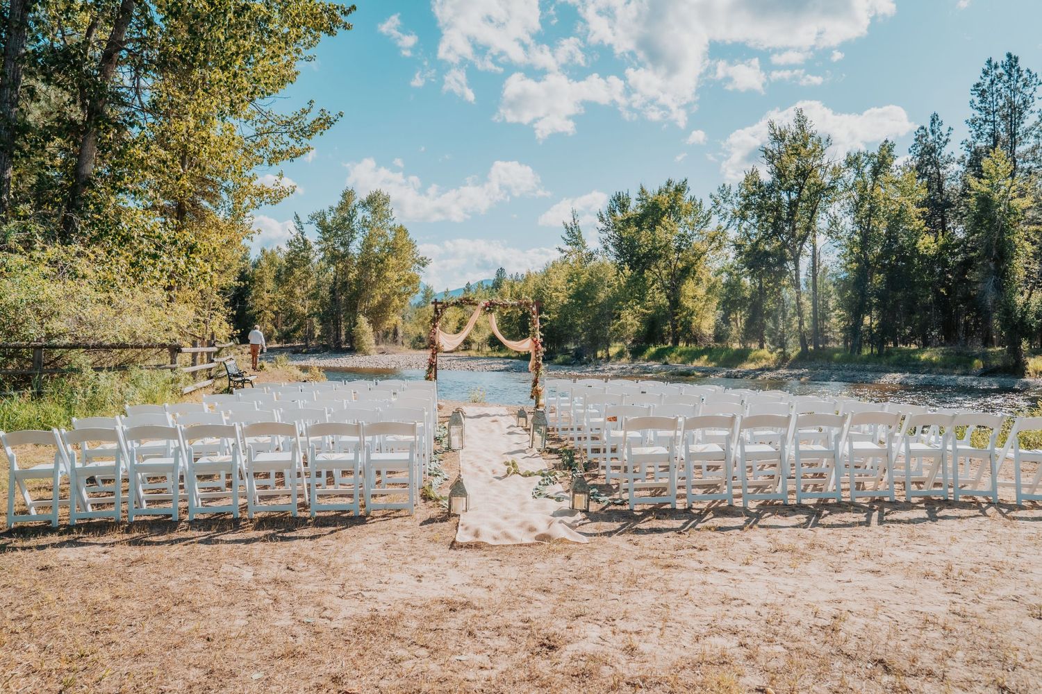 A panoramic sequence of a rustic outdoor wedding ceremony setup with white chairs arranged in rows under tall pine trees.