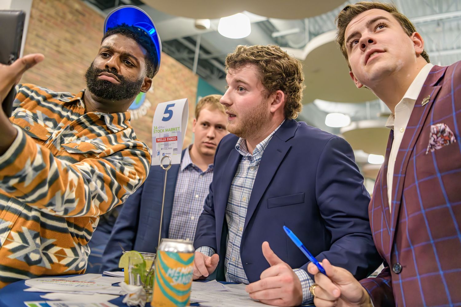 A diverse group of people playing board games together in a fun social gathering atmosphere.