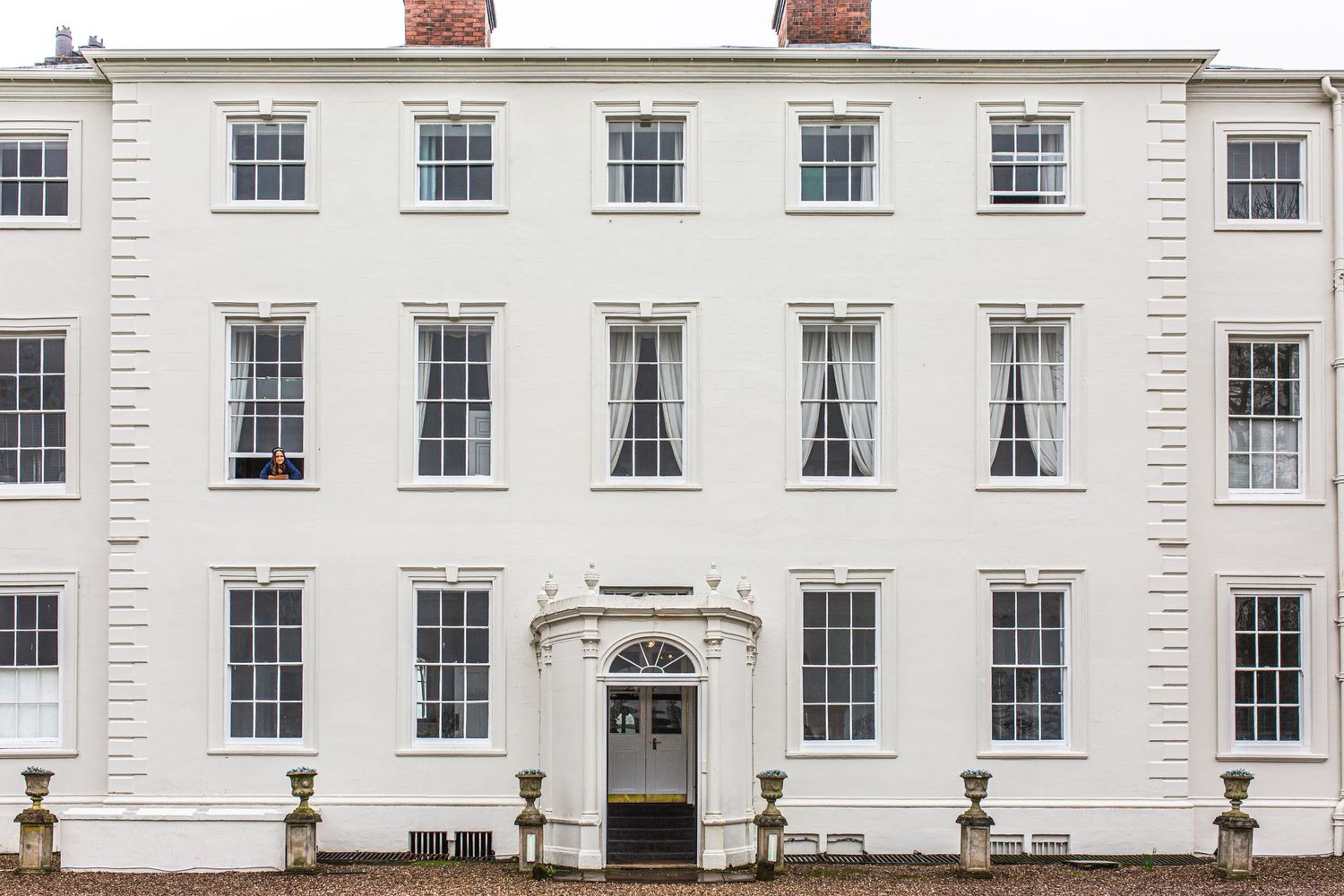 Elegant white Georgian townhouse with symmetrical windows and ornate entrance doorway.