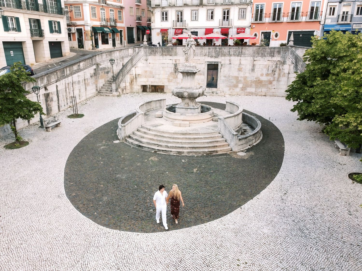 Romantic couple walking through the streets of Lisbon before their destination wedding in Portugal