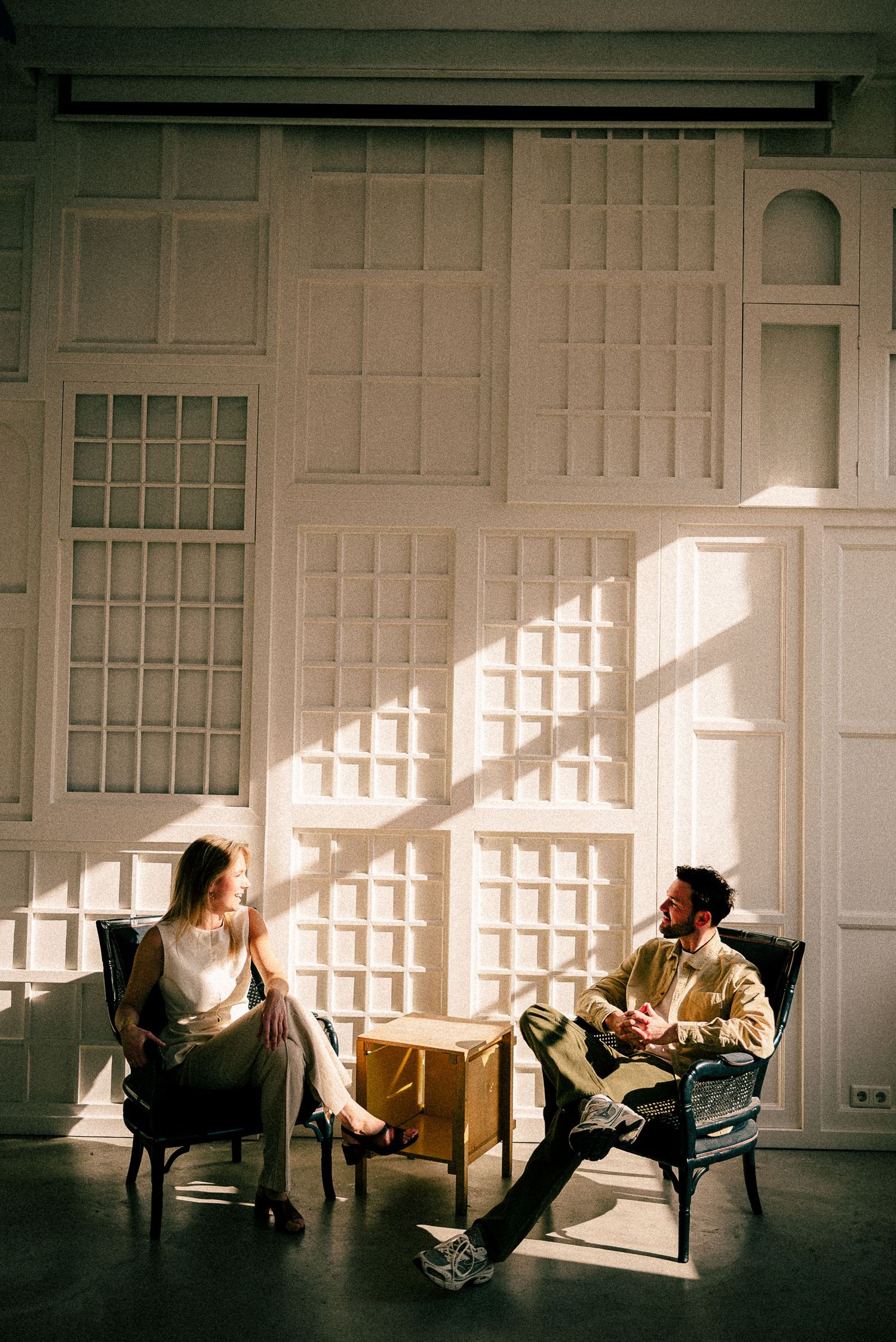 A couple shares a moment outside Ristorante Giglio with orange walls and umbrellas.