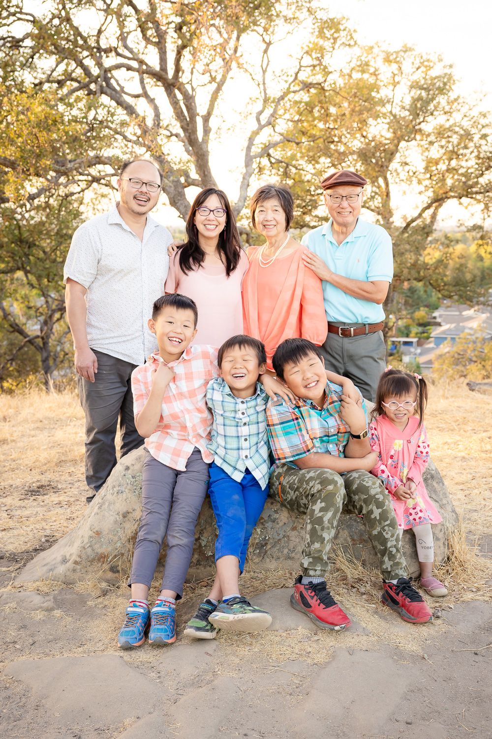 Family smiles at an extended family photo session with Bay Area Photographer Cindy Tucey during golden hour in San Jose