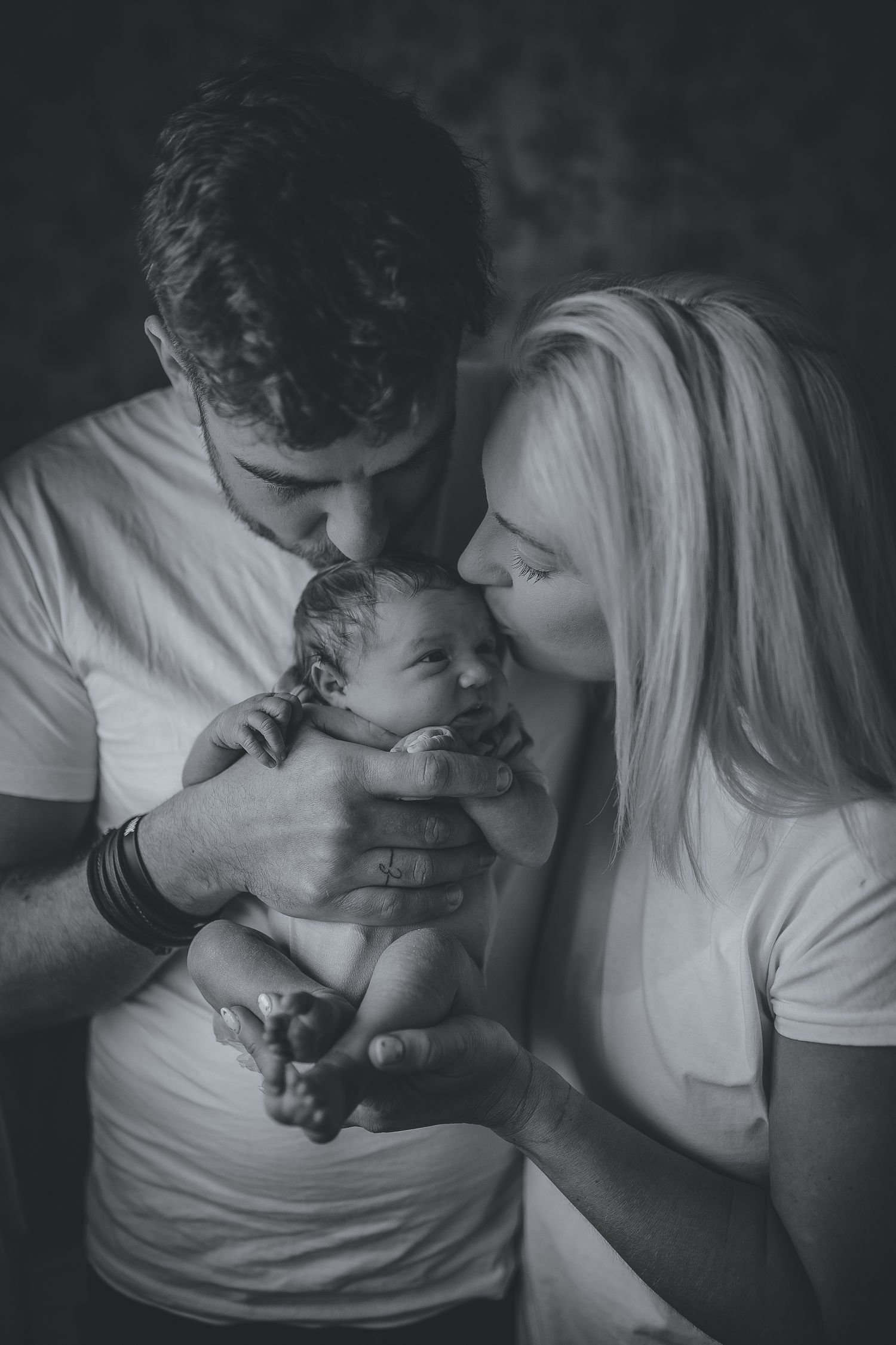 A black and white intimate portrait of new parents cradling their newborn. Photographer. Hull. East Yorkshire. Photography