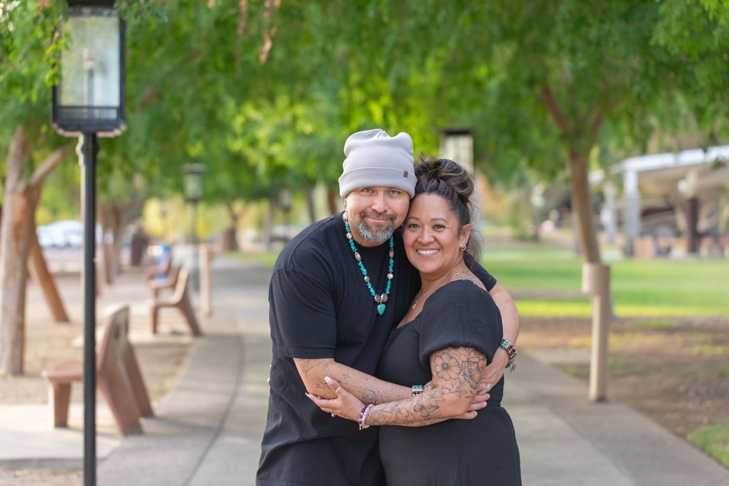 Couple sharing affectionate moment outdoors in casual winter attire.