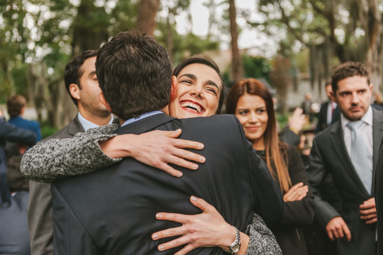 Wedding guest hugs newlywed husband.