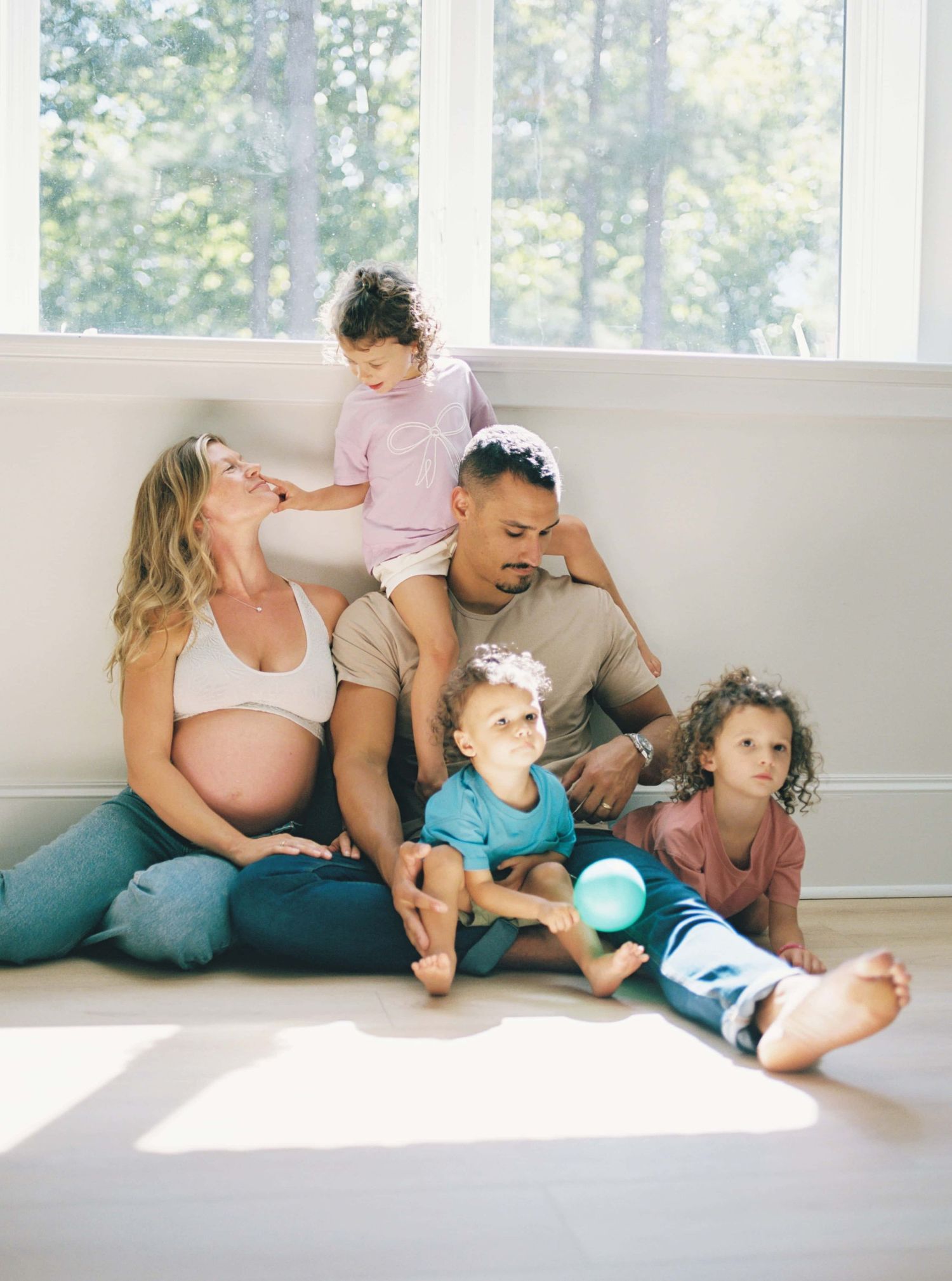 A playful sequence of parent and child interactions showing affectionate moments on a white couch.
