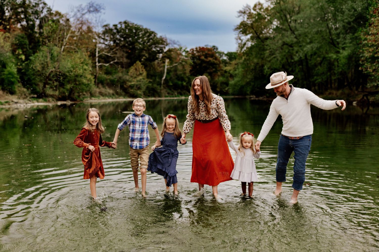 Family photography playing in a creek in Marion Indiana