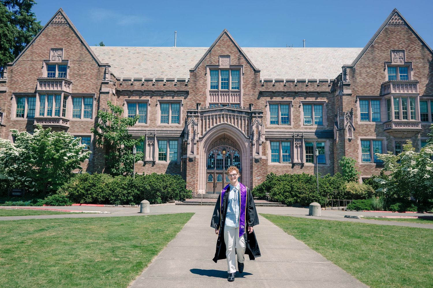 University of Washington graduate posing in front of Guggenheim Hall during a Seattle graduation photography session