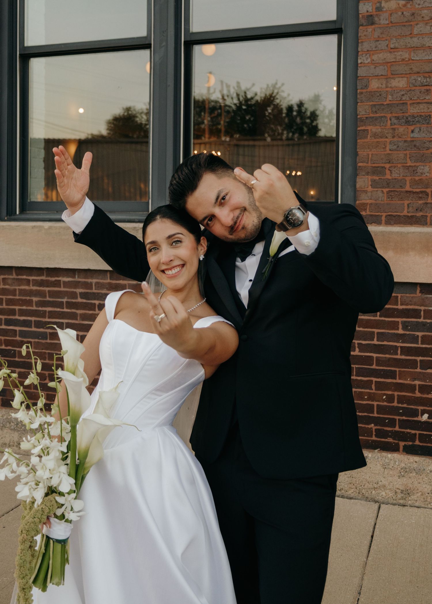 Wedding couple poses playfully in a series of four candid shots outside a brick building.