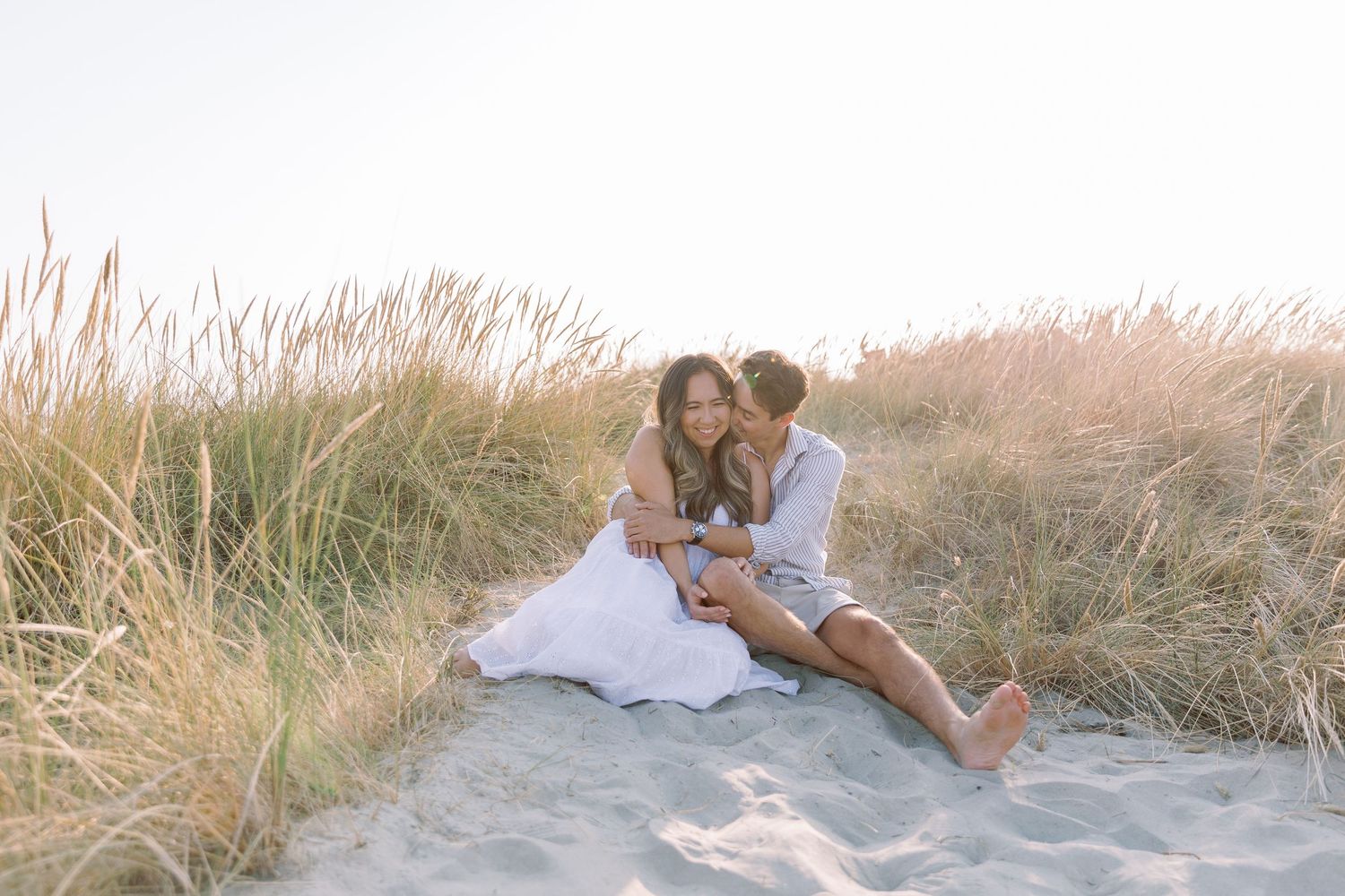 A couple walking together and sharing romantic moments on a beach at sunset creates a dreamy coastal atmosphere.