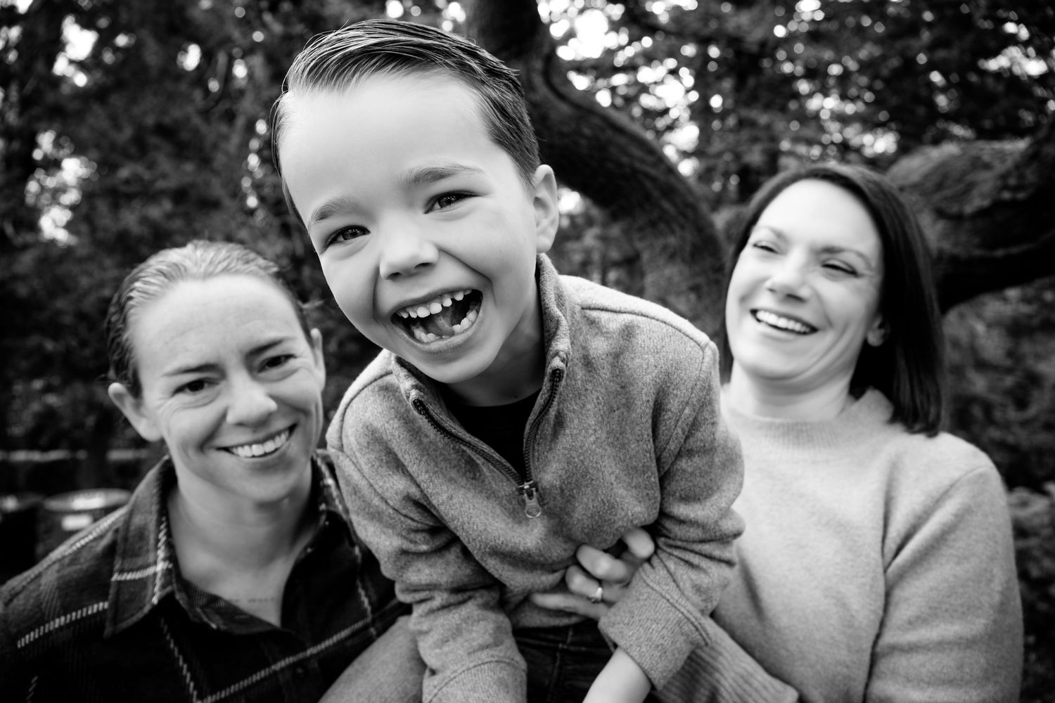 A series of black and white candid photos showing joyful expressions and laughter between friends.