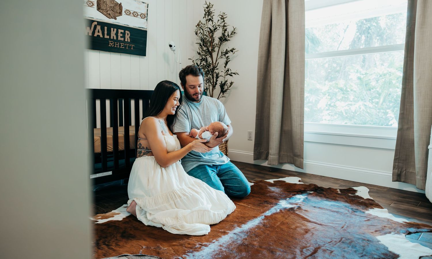 New family cuddling their newborn during in-home lifestyle session in Stuart Florida, newborn photographer in home session, treasure coast