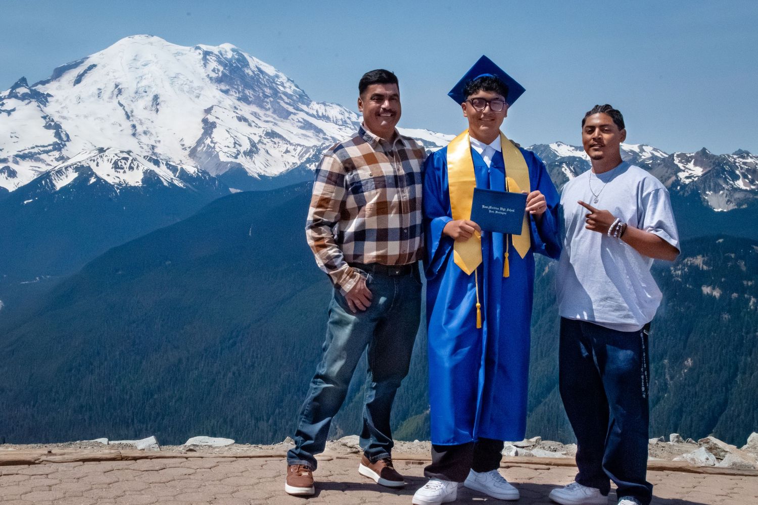Graduate posing with family member during a Mount Rainier graduation photo session in Washington