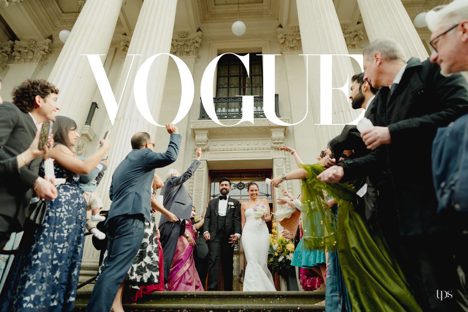 Bride and groom exit wedding venue on grand steps as guests celebrate, with Vogue magazine logo overlay.