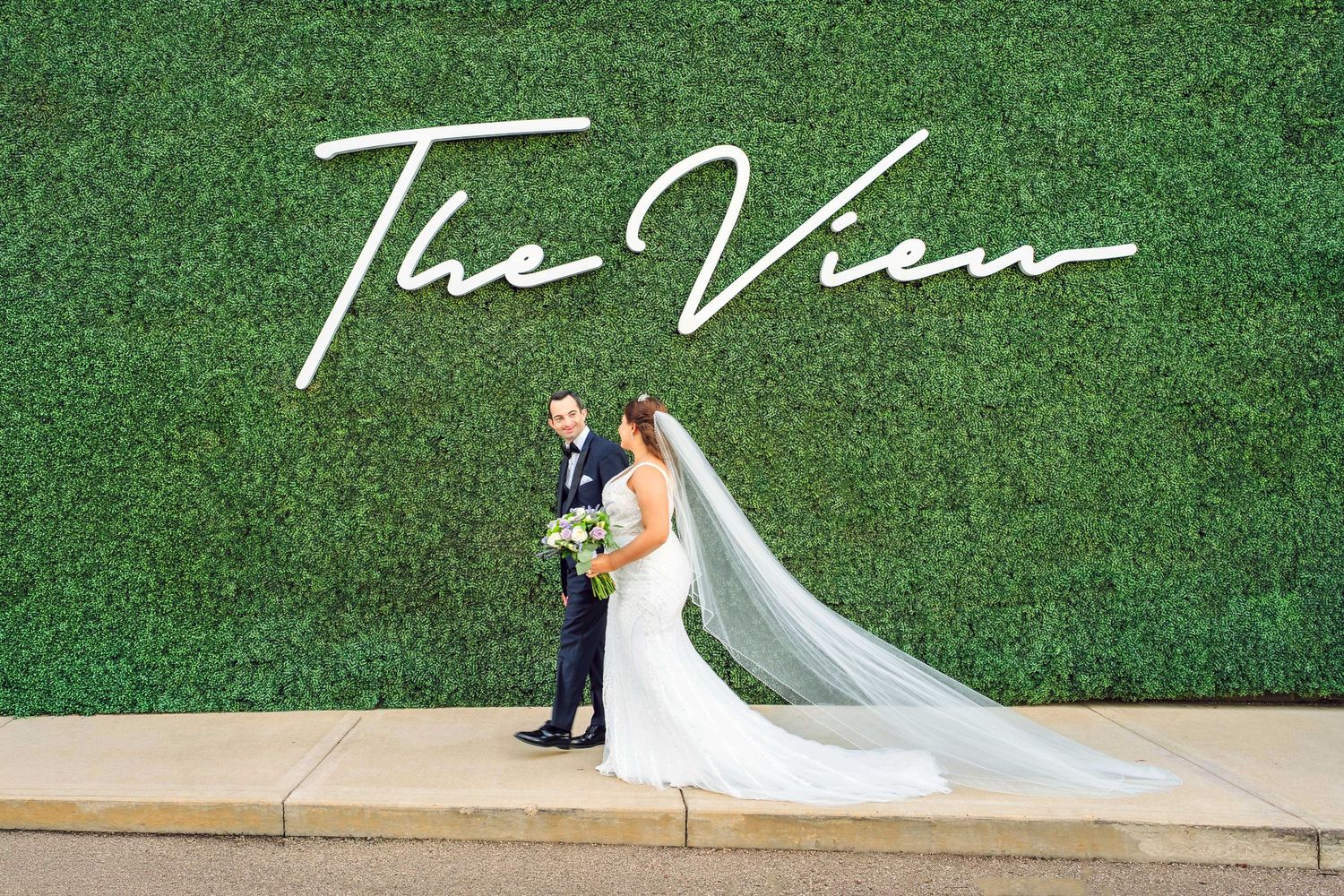 A bride and groom pose in front of The View at Mt. Adams Wedding Venue