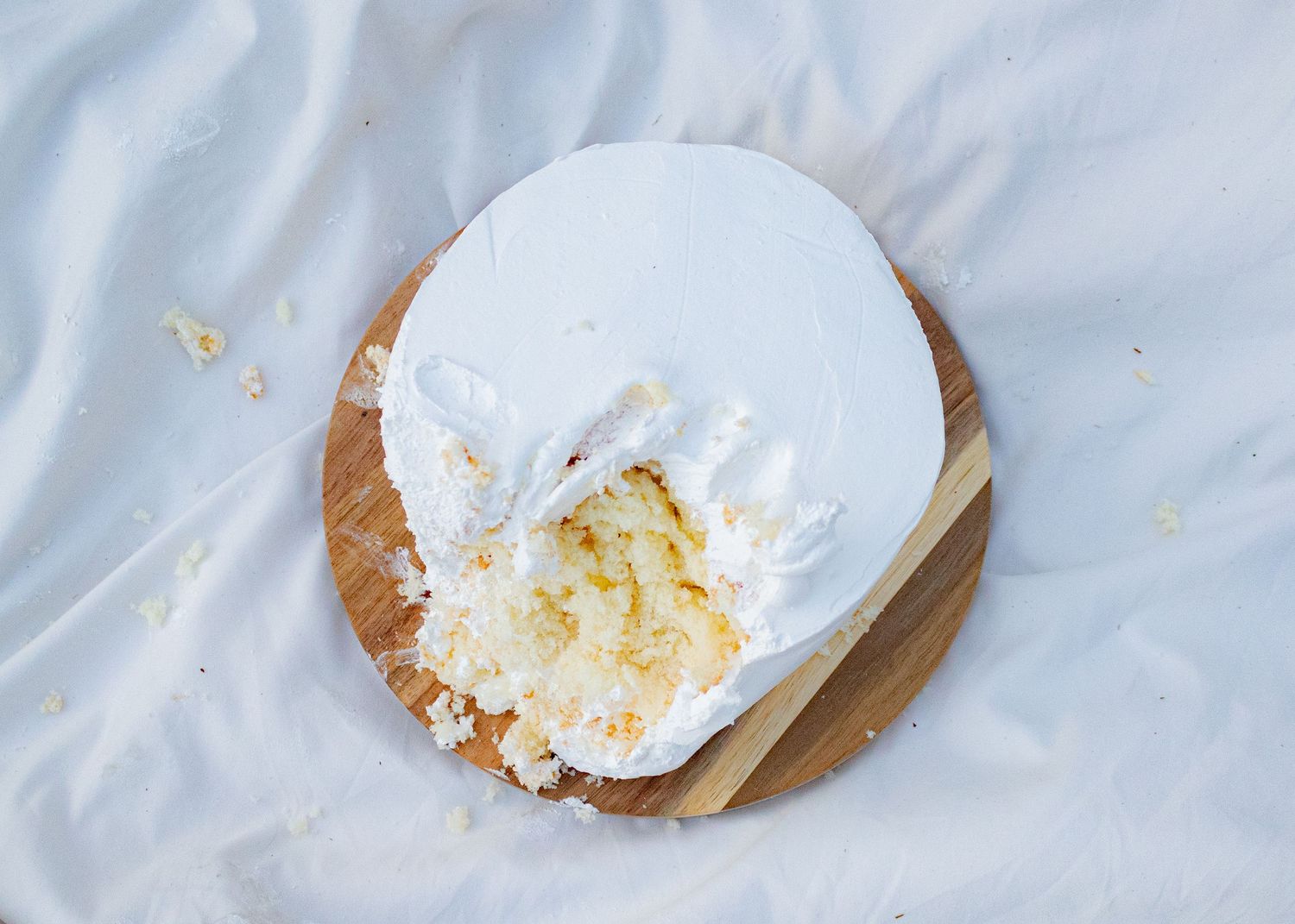 White cream or frosting smeared across a light colored surface.