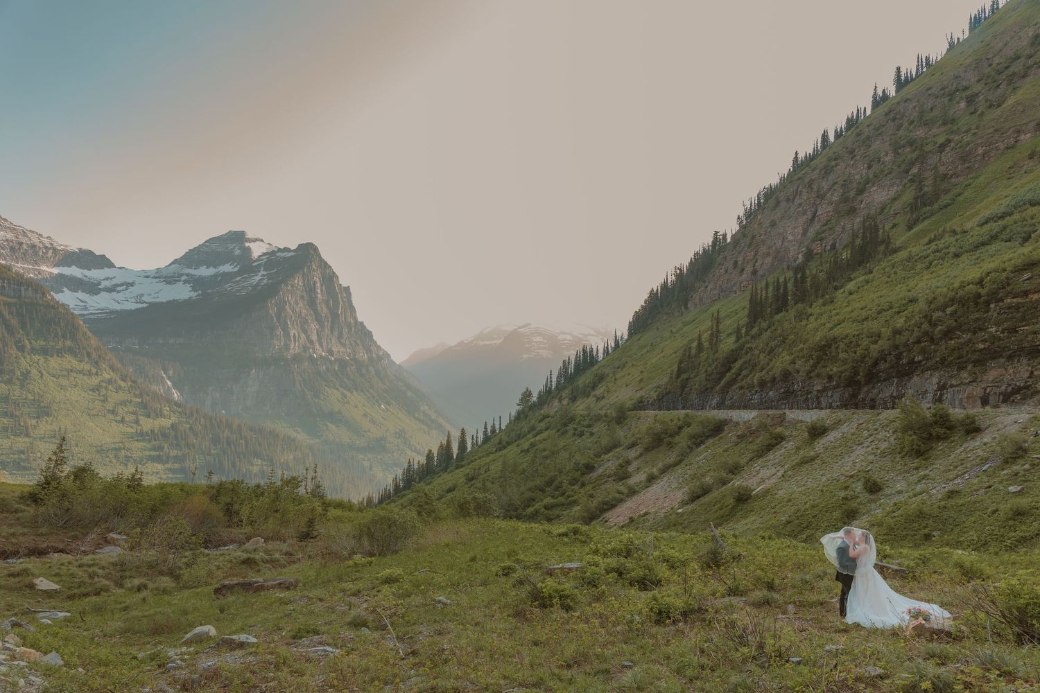 Mountain wedding photos capture scenic moments in Glacier National Park against dramatic rocky peaks and alpine meadows.