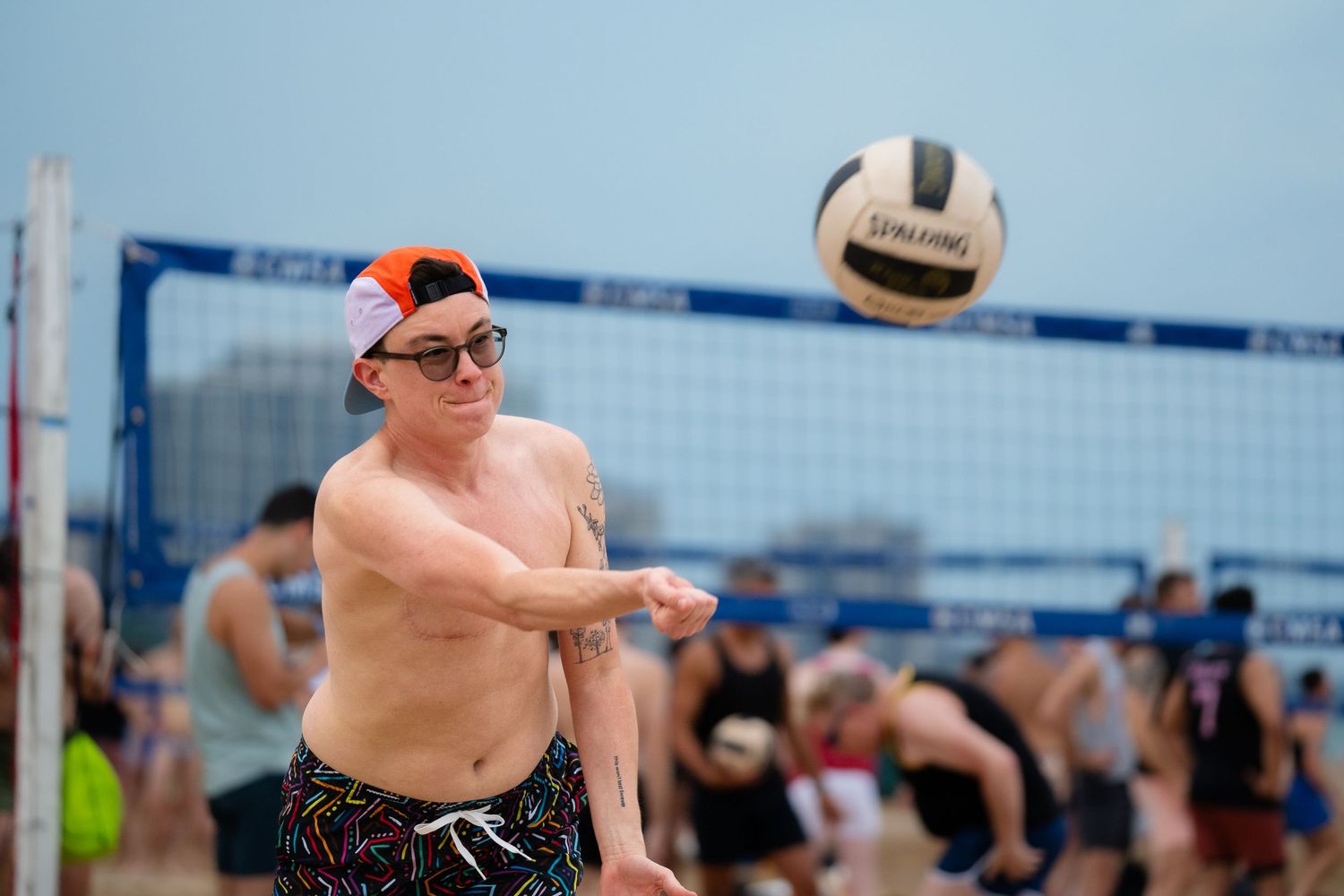 A volleyball athlete begins the point with a serve