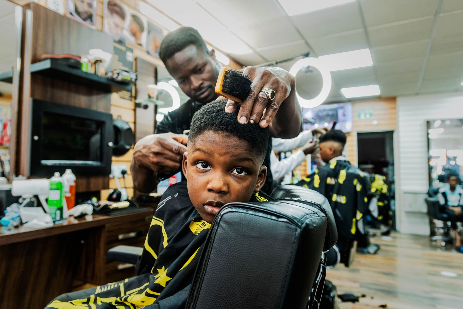 Documentary portrait of a barber cutting hair in an Ipswich barbershop, Suffolk