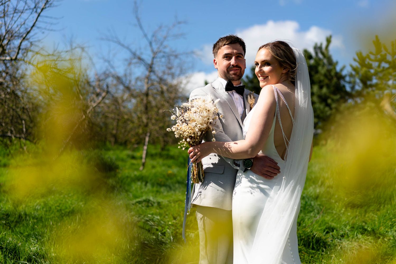 Bride and Groom in the apple orchard at The Corn Barn Wedding venue in Cullompton, Devon