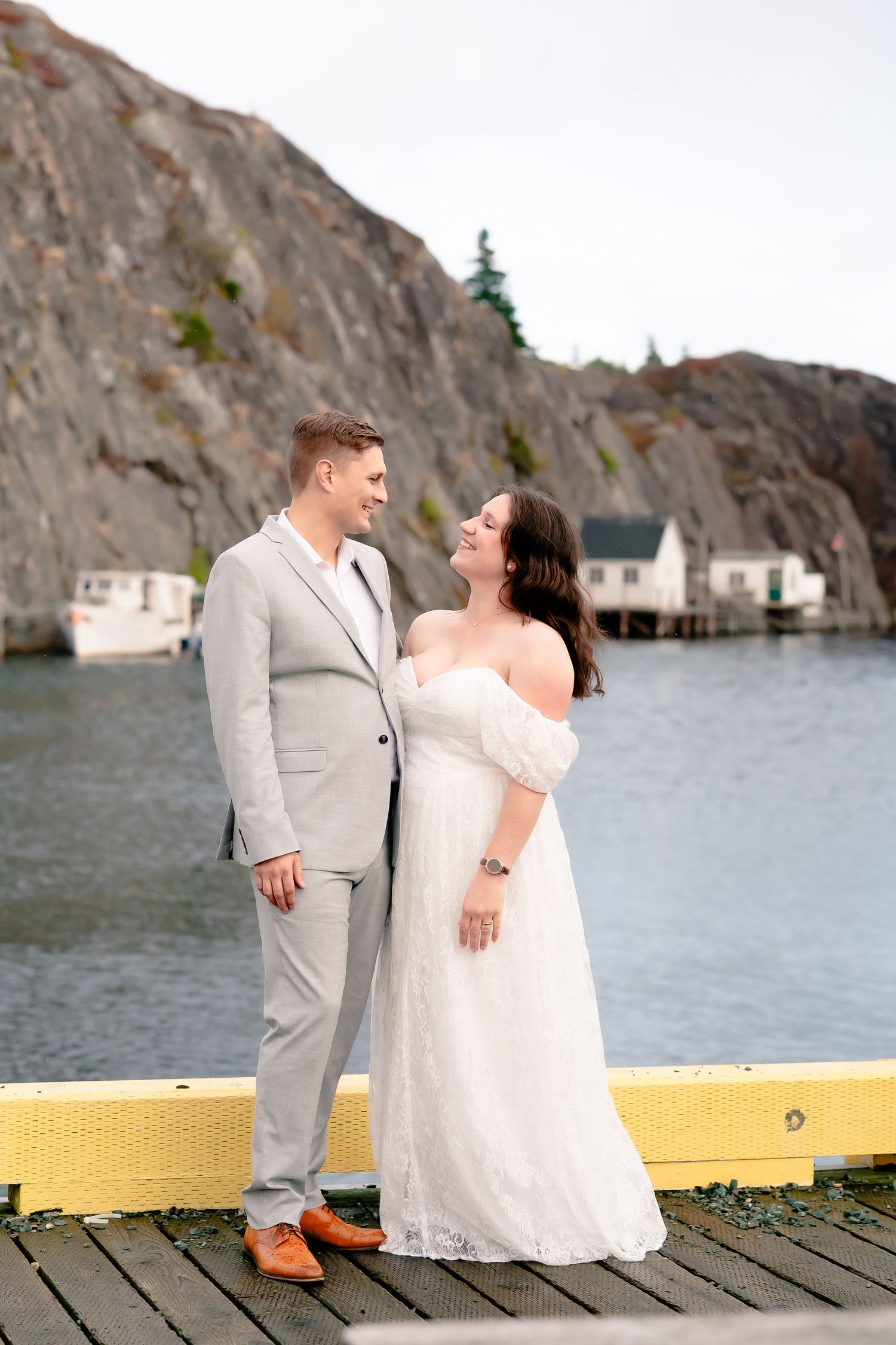 Couple standing on the cliffs of Quidi Vidi with the ocean behind them after their elopement ceremony at St. John's City Hall