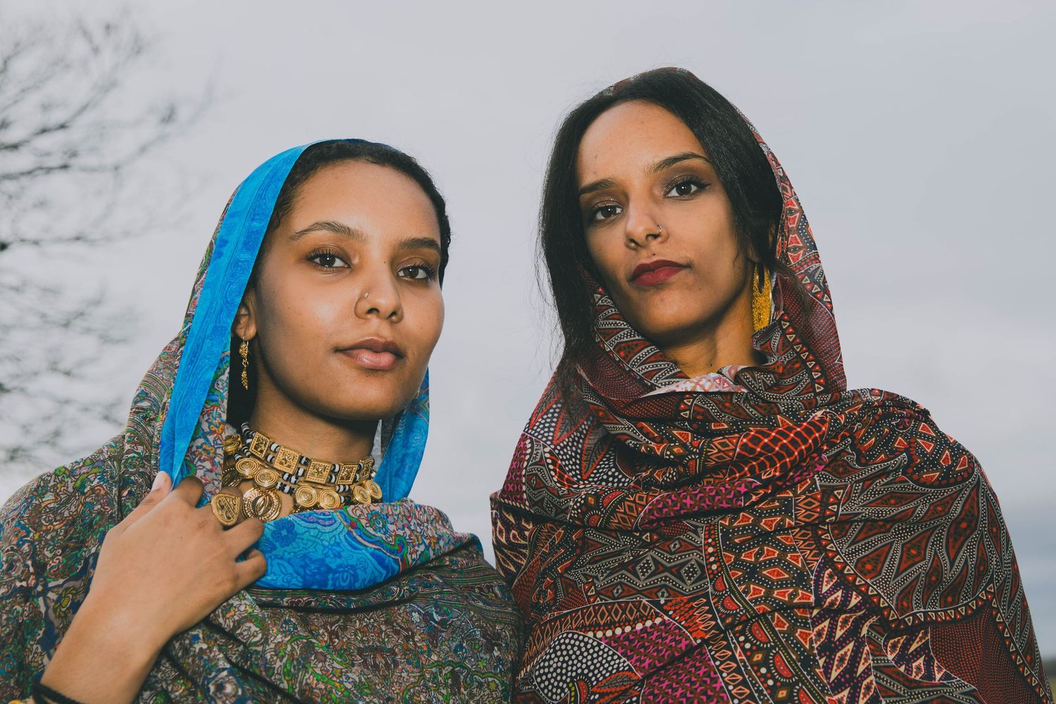 Portrait of Sudanese,Welsh sisters wearing silk Toub in NORTH WALES, designed by HIMA RAHAMA. Jewellery by KUKU Jewellery. fashion.