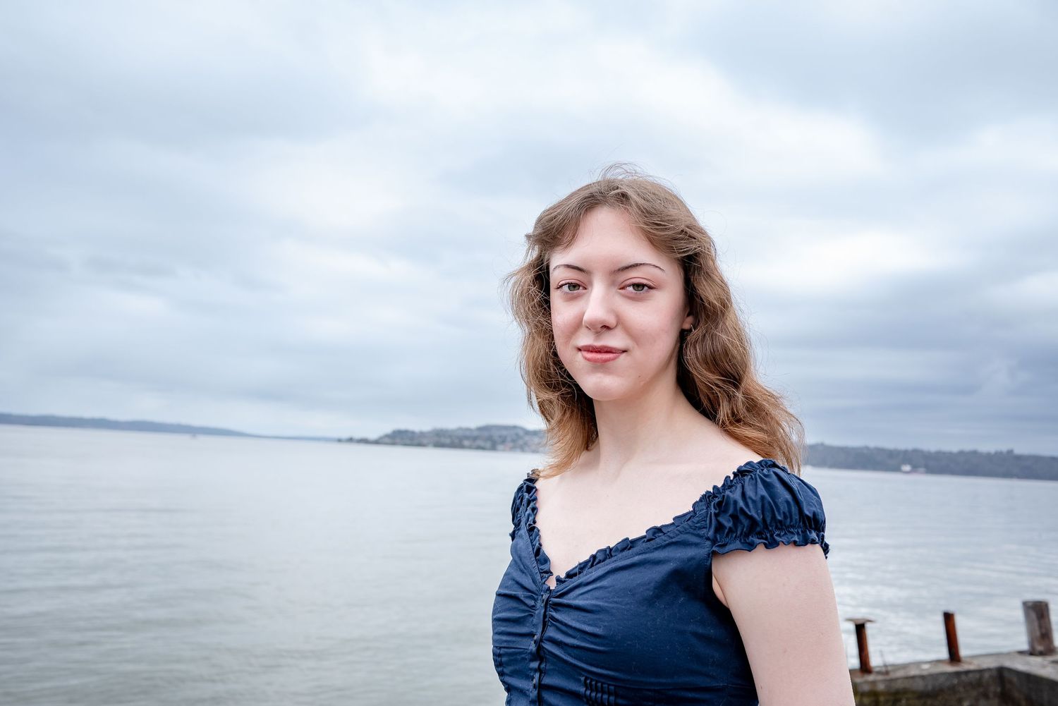 Tacoma waterfront senior graduation portrait session in Washington featuring graduate at Dickman Mill Park beside Commencement Bay.