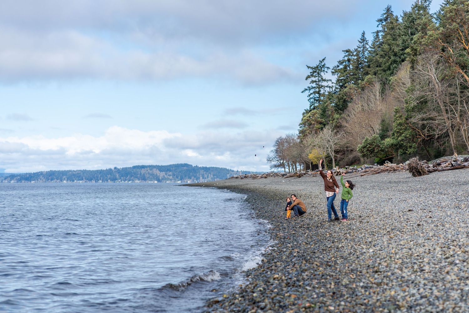 Family throwing rocks at Lincoln Park's beach.