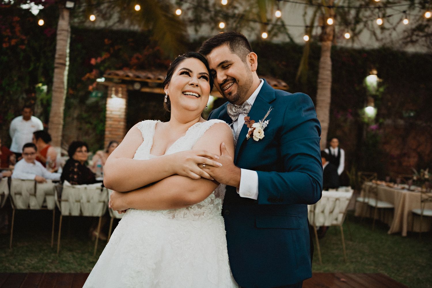 Couple enjoying their first dance, embracing each other with smiles, radiating warmth and love during their wedding