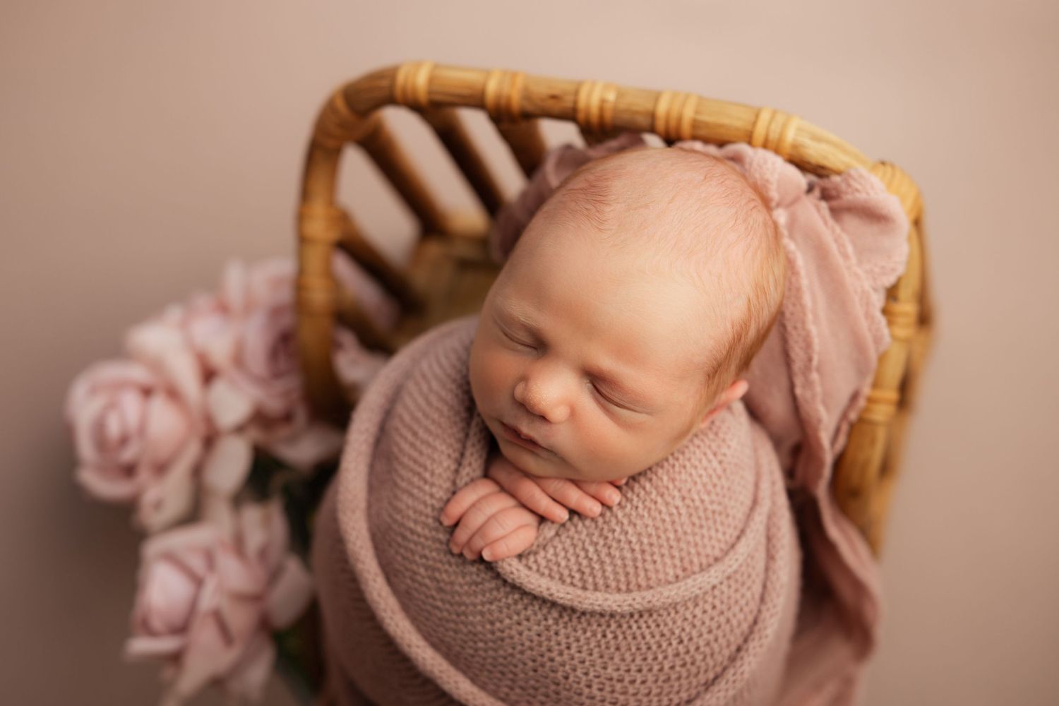 Neutral toned nursery interior with plaid curtains and cozy seating area.