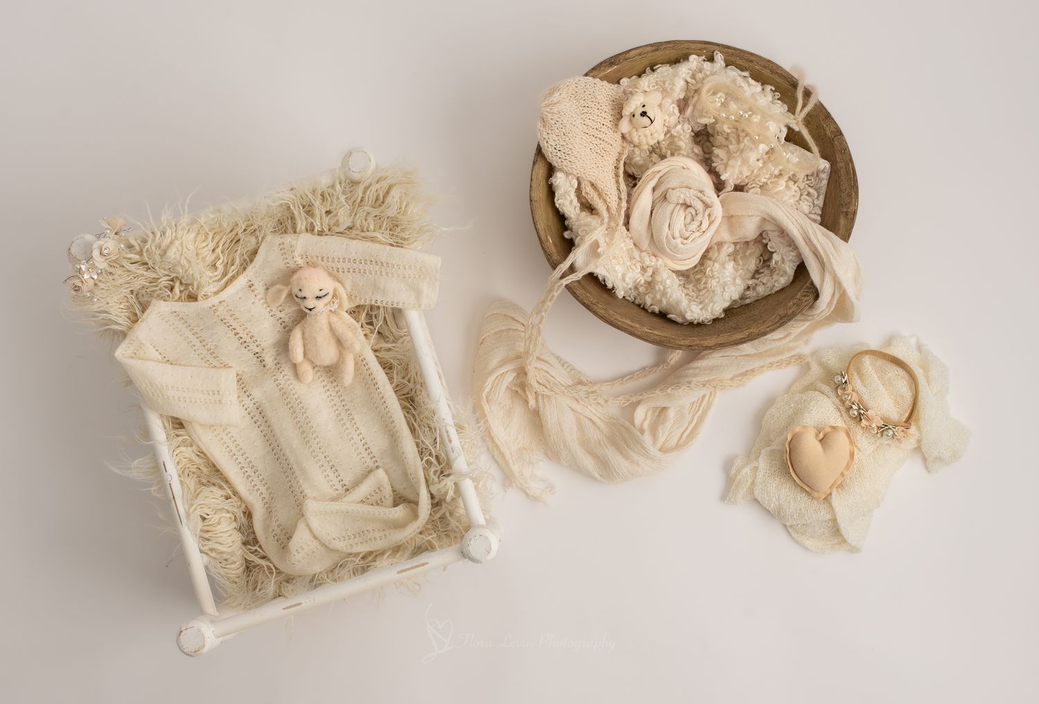 Neutral newborn photography props set with of wraps, floral and pearl headbands, bowl, bed, lamb doll and cream outfit.