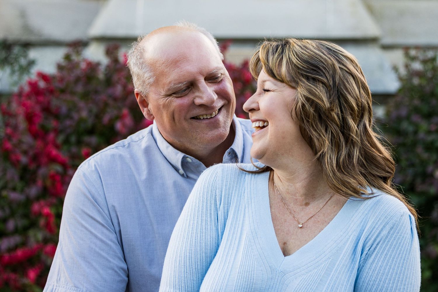 Frederick Maryland Wedding Photographer    A couple shares loving moments while relaxing together outdoors in light blue clothing.