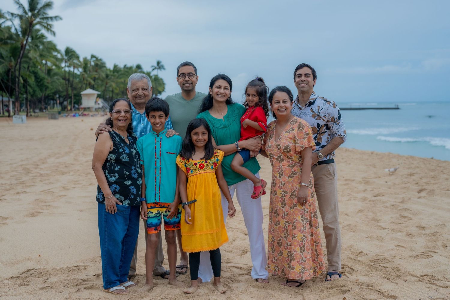 family on waikiki beach posing for a photo