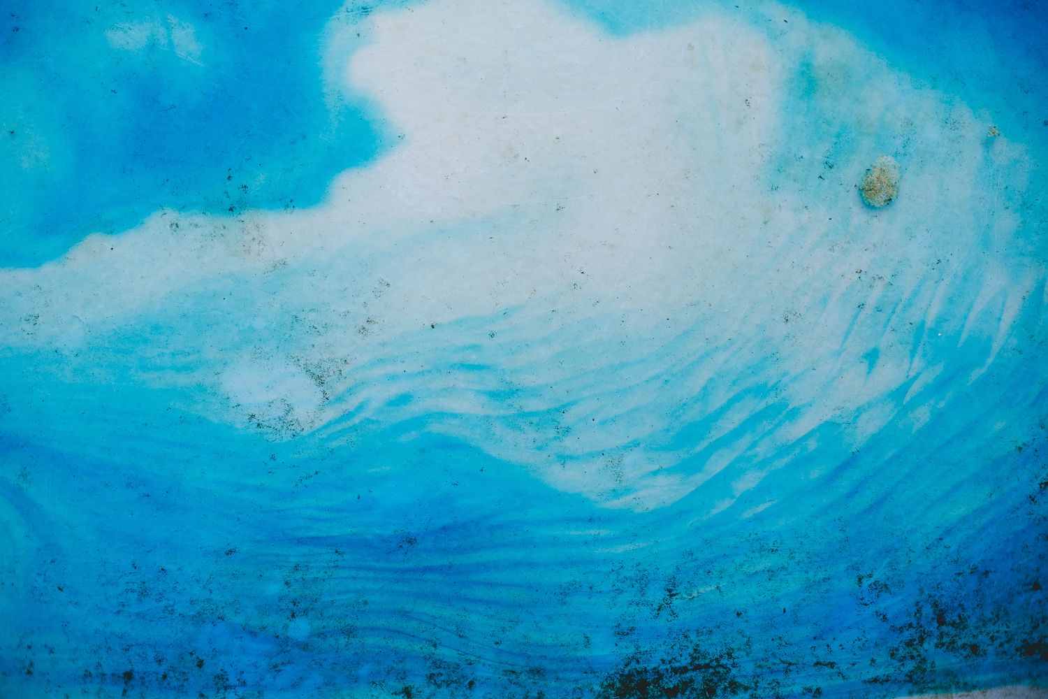 Abstract underwater scene with bright blue waves and white light filtering through.
