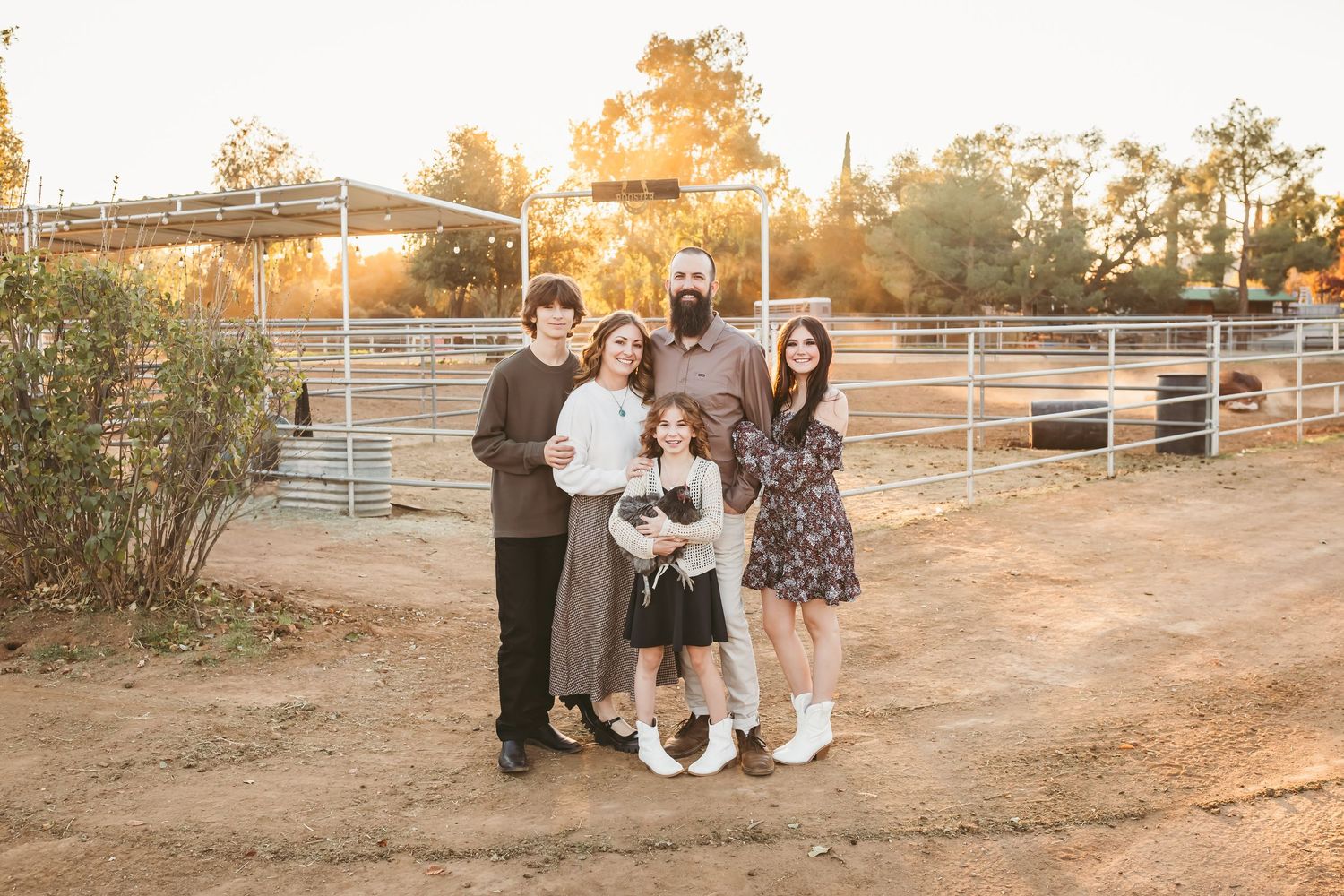 A series of warm sunset photos showing people gathered outdoors near white fencing on a dusty rural path.